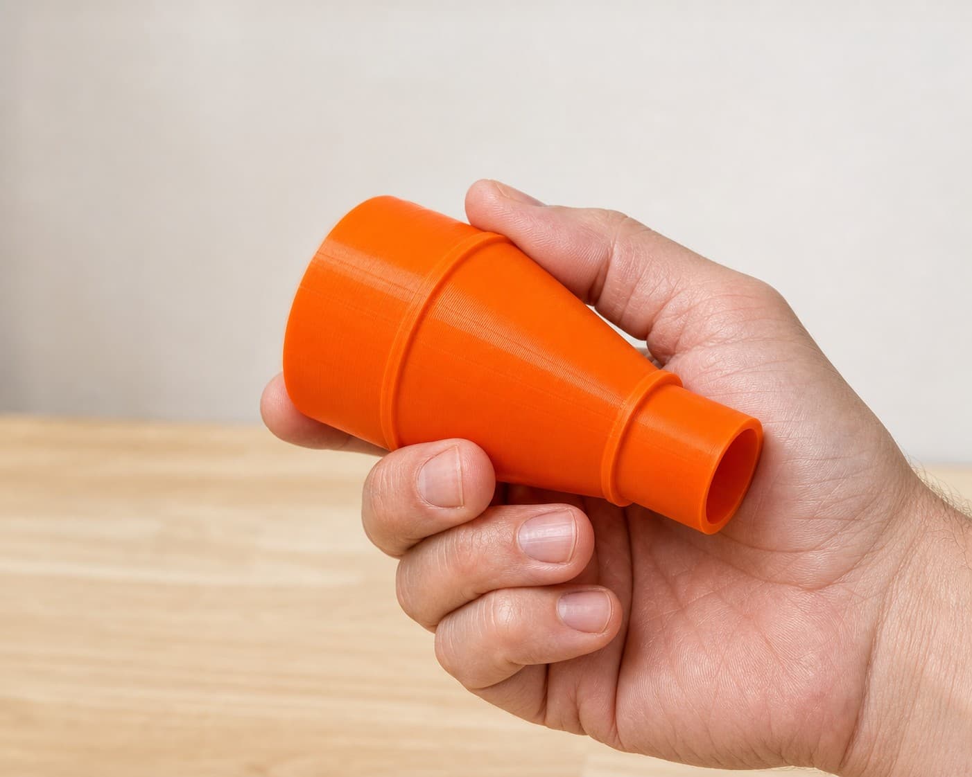 The BO5041 to Craftsman 20G dust adapter held in one hand to show its size