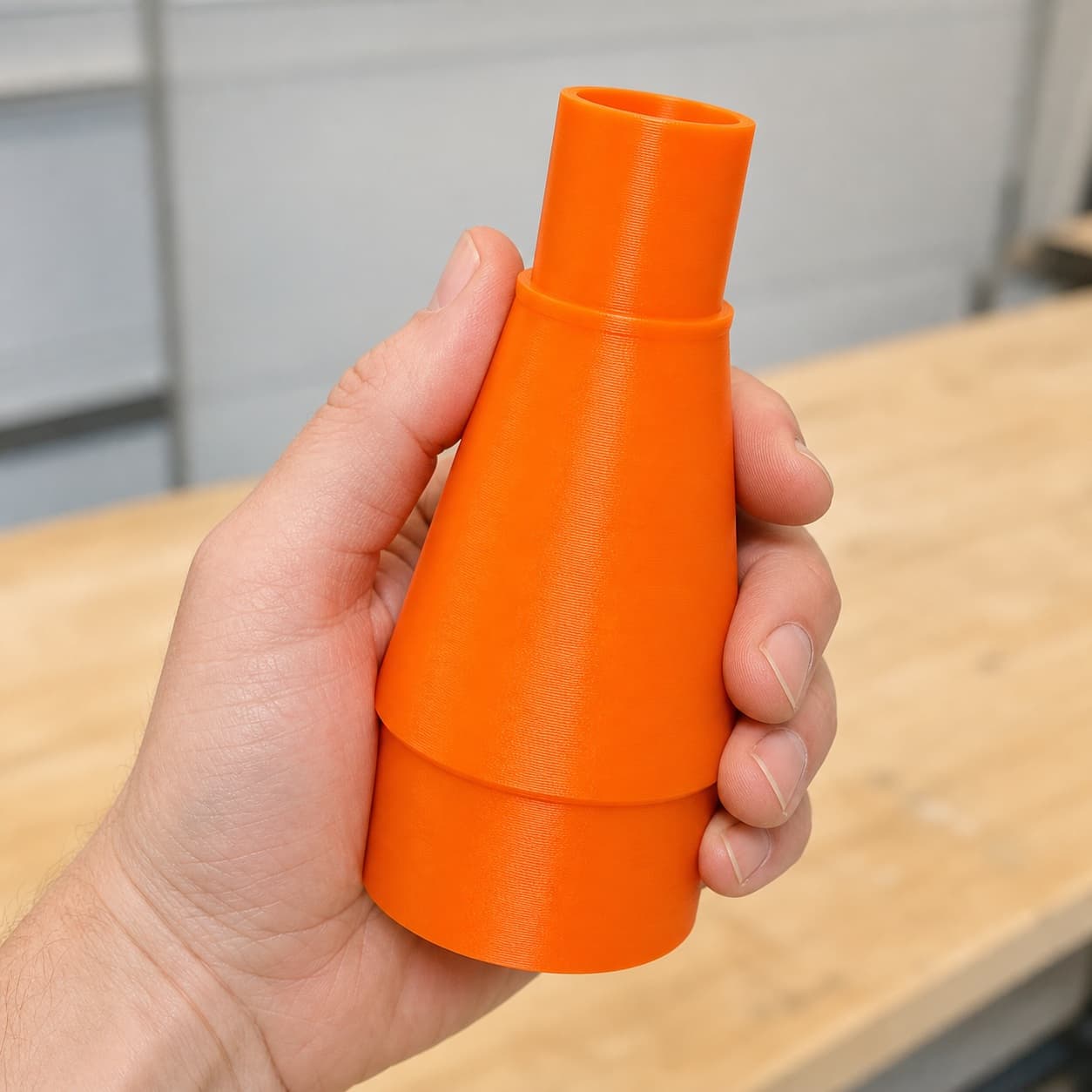 The BO5041 to 2.25" Duct dust adapter held in one hand to show its size