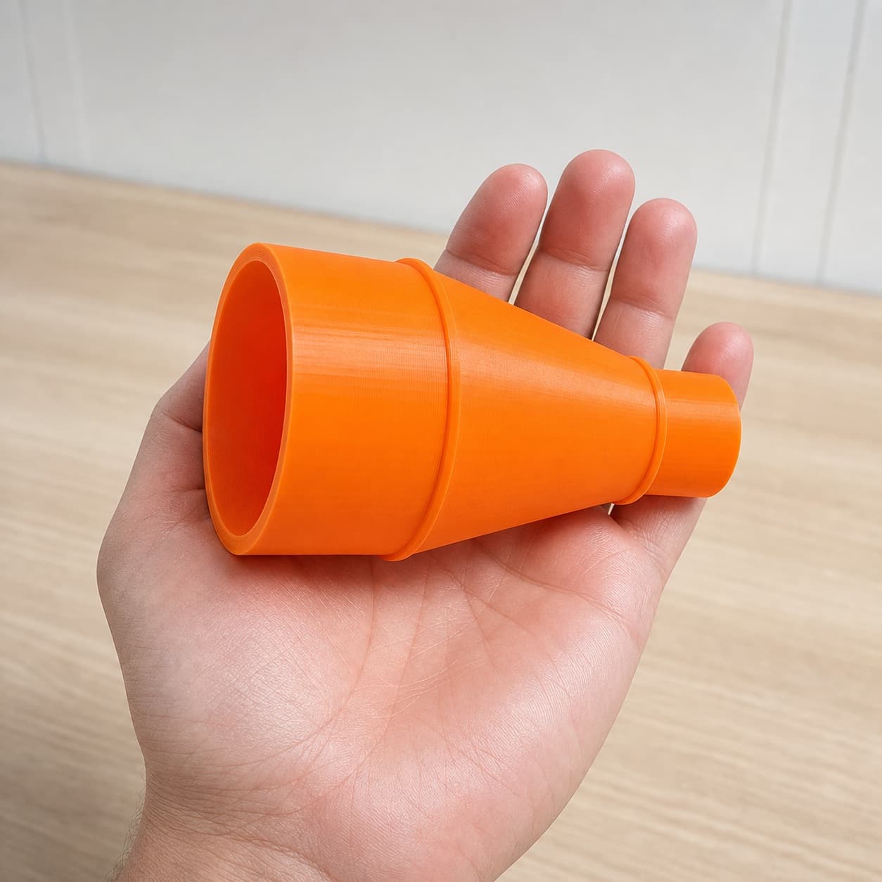 The CMCS550B to 2.5" Duct dust adapter held in one hand to show its size