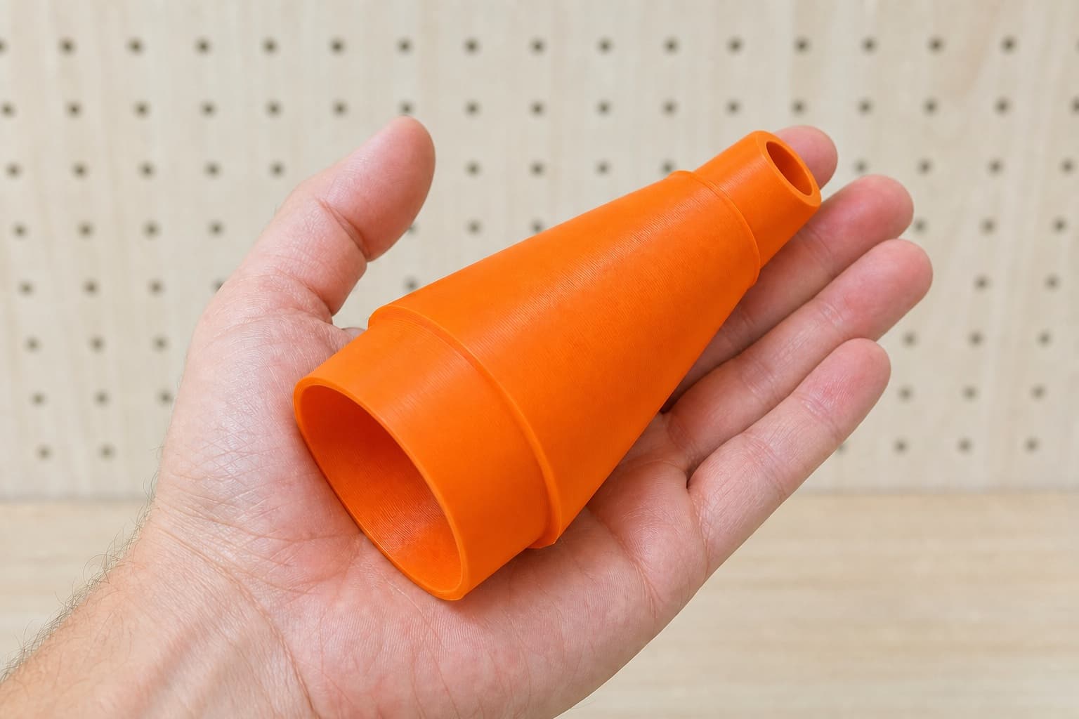 The 2737-20 to 3" Duct dust adapter held in one hand to show its size