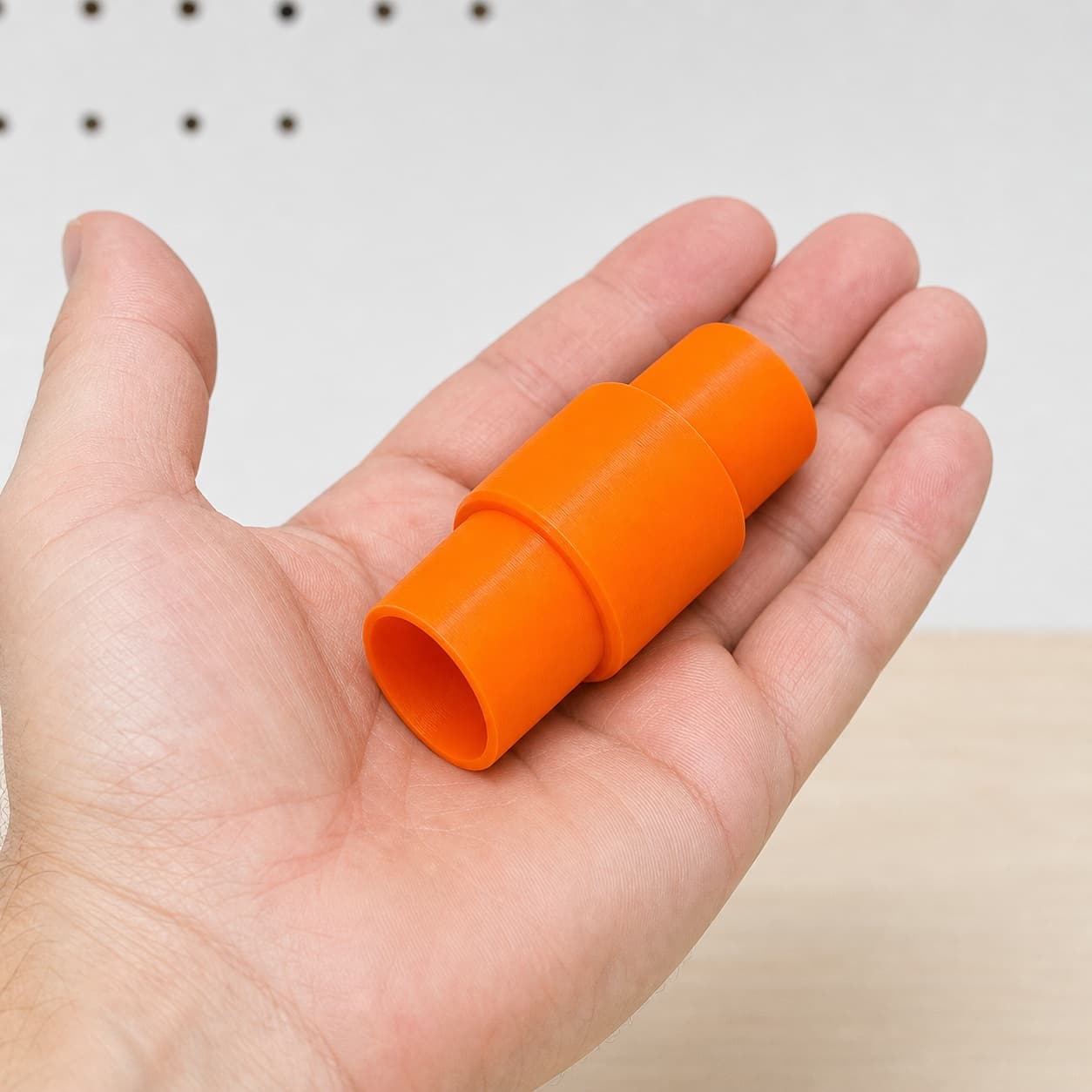 The DRT50 to Festool CT 36 dust adapter held in one hand to show its size