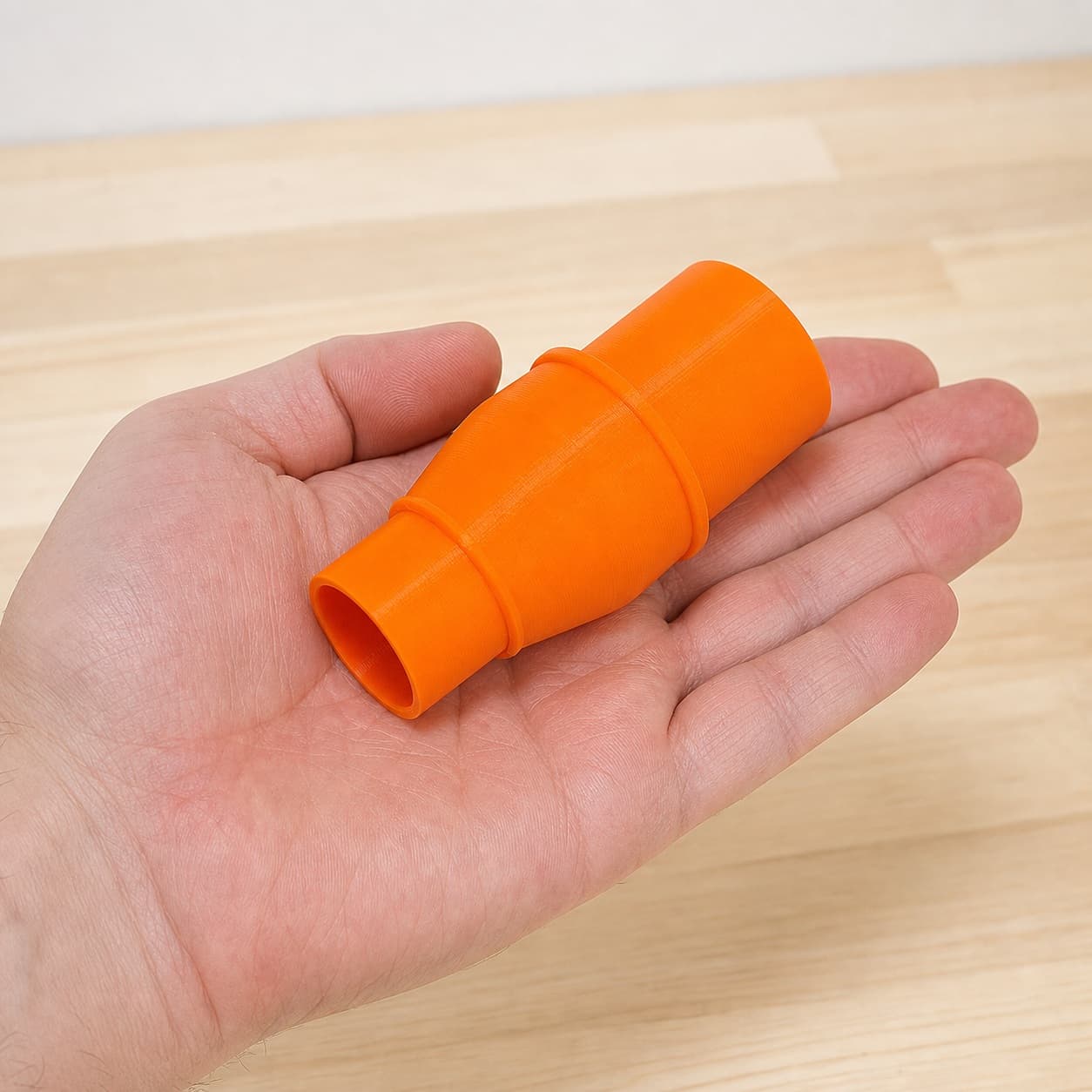 The TP-CS 18/190 Li to 1" Duct dust adapter held in one hand to show its size