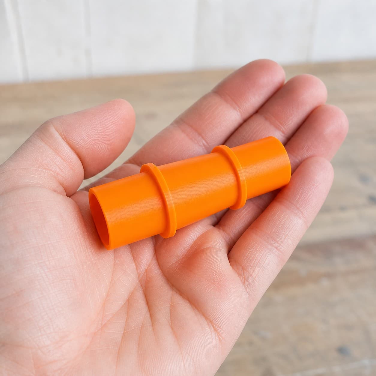 The DSP600 to 1.5" Duct dust adapter held in one hand to show its size