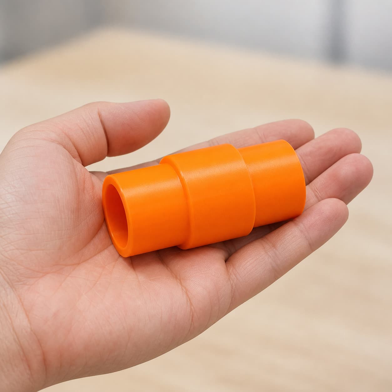The XSH06Z to Festool CT 36 dust adapter held in one hand to show its size