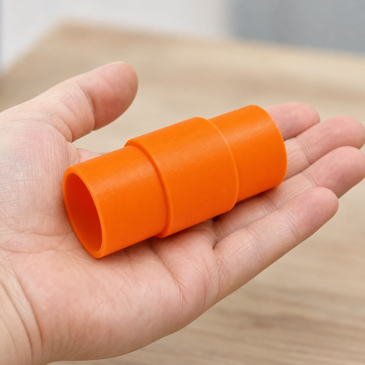 The 3386-01 to 36mm Festool dust adapter held in one hand to show its size