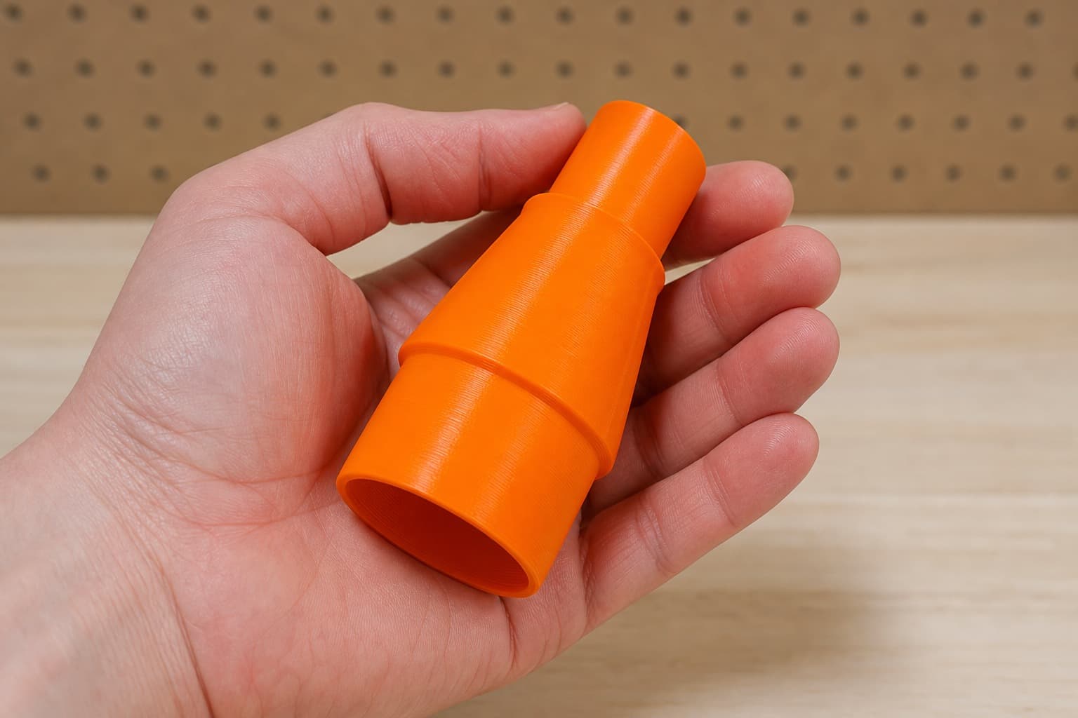 The DKP180 to Festool CT MIDI dust adapter held in one hand to show its size