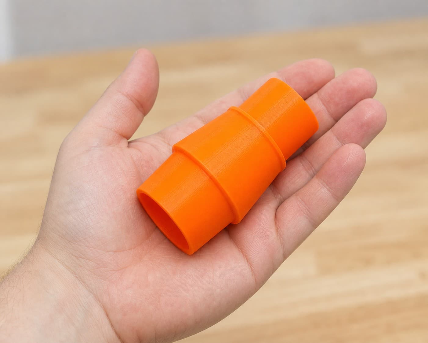 The DKP180 to Festool CT 36 dust adapter held in one hand to show its size