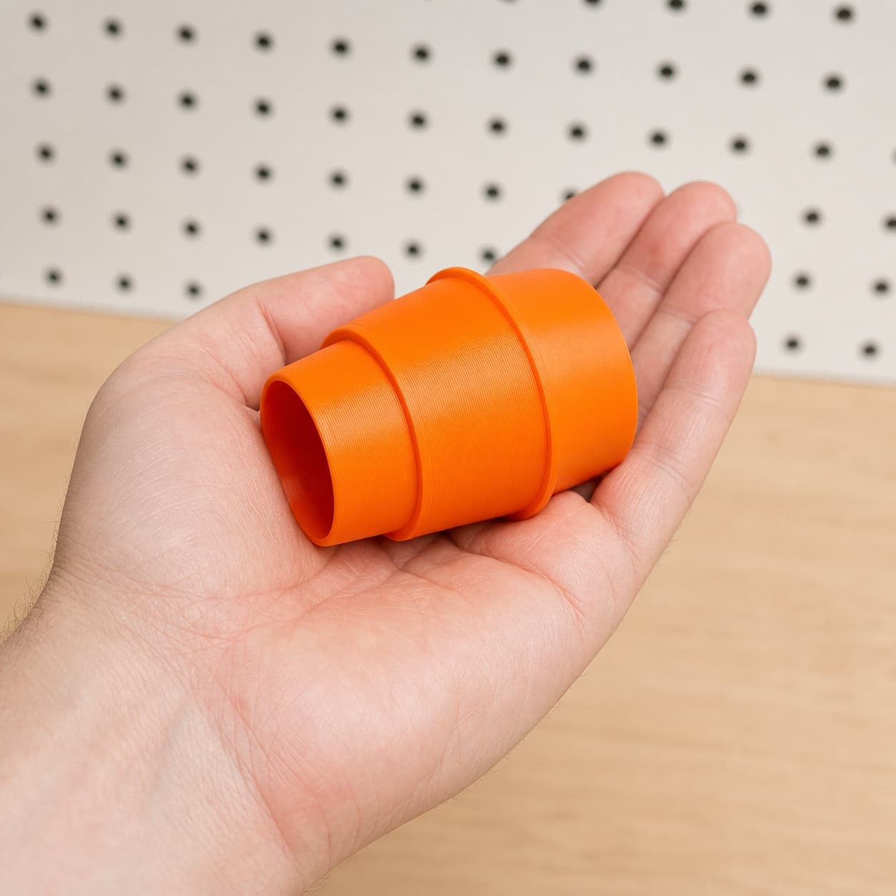 The SM3055LW to Craftsman 16G dust adapter held in one hand to show its size
