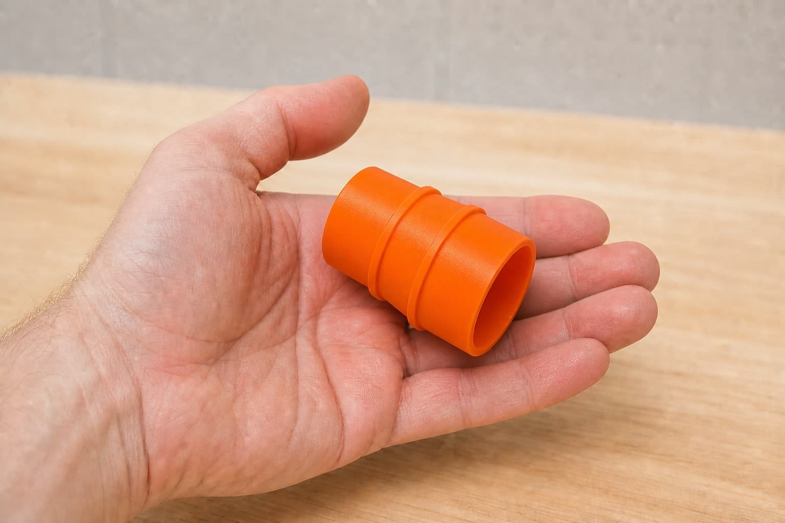 The SPT99 to Kobalt KCV-9-06 dust adapter held in one hand to show its size