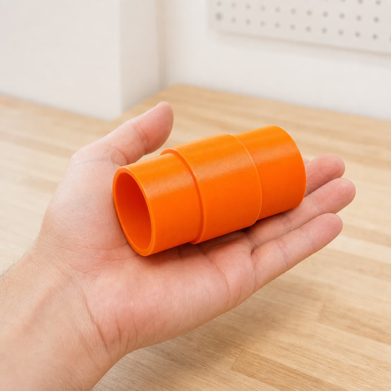 The SPT99 to Bauer 6G Vac dust adapter held in one hand to show its size