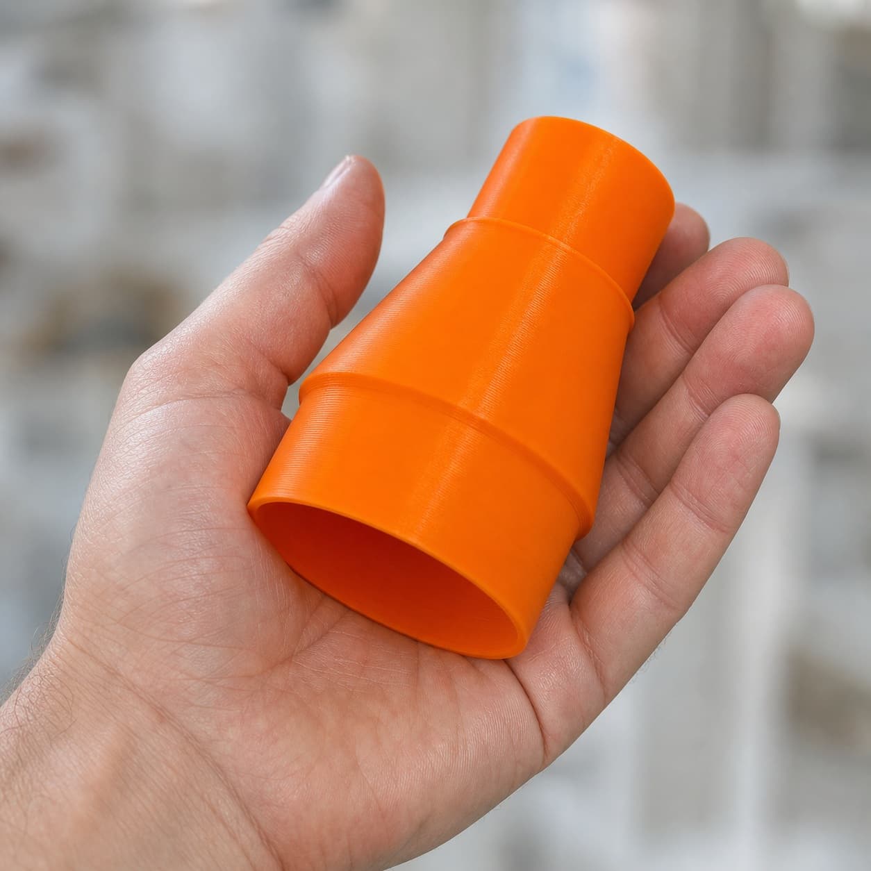The CMXETAX to 36mm Festool dust adapter held in one hand to show its size