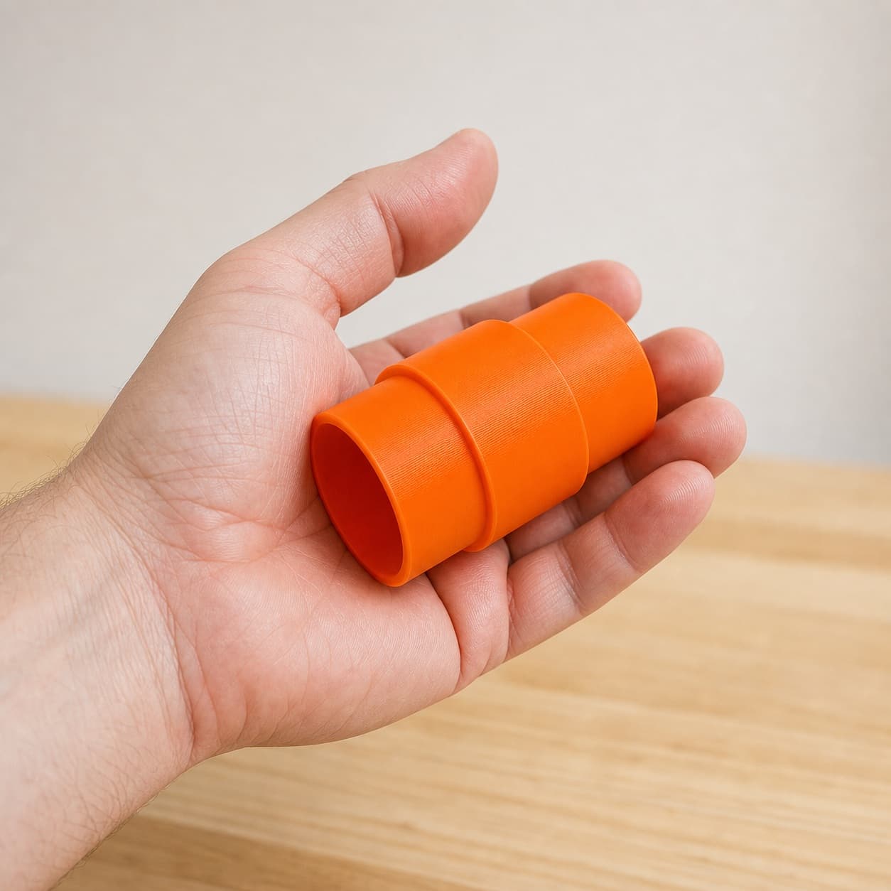 The CMXETAX to 2.25" Duct dust adapter held in one hand to show its size