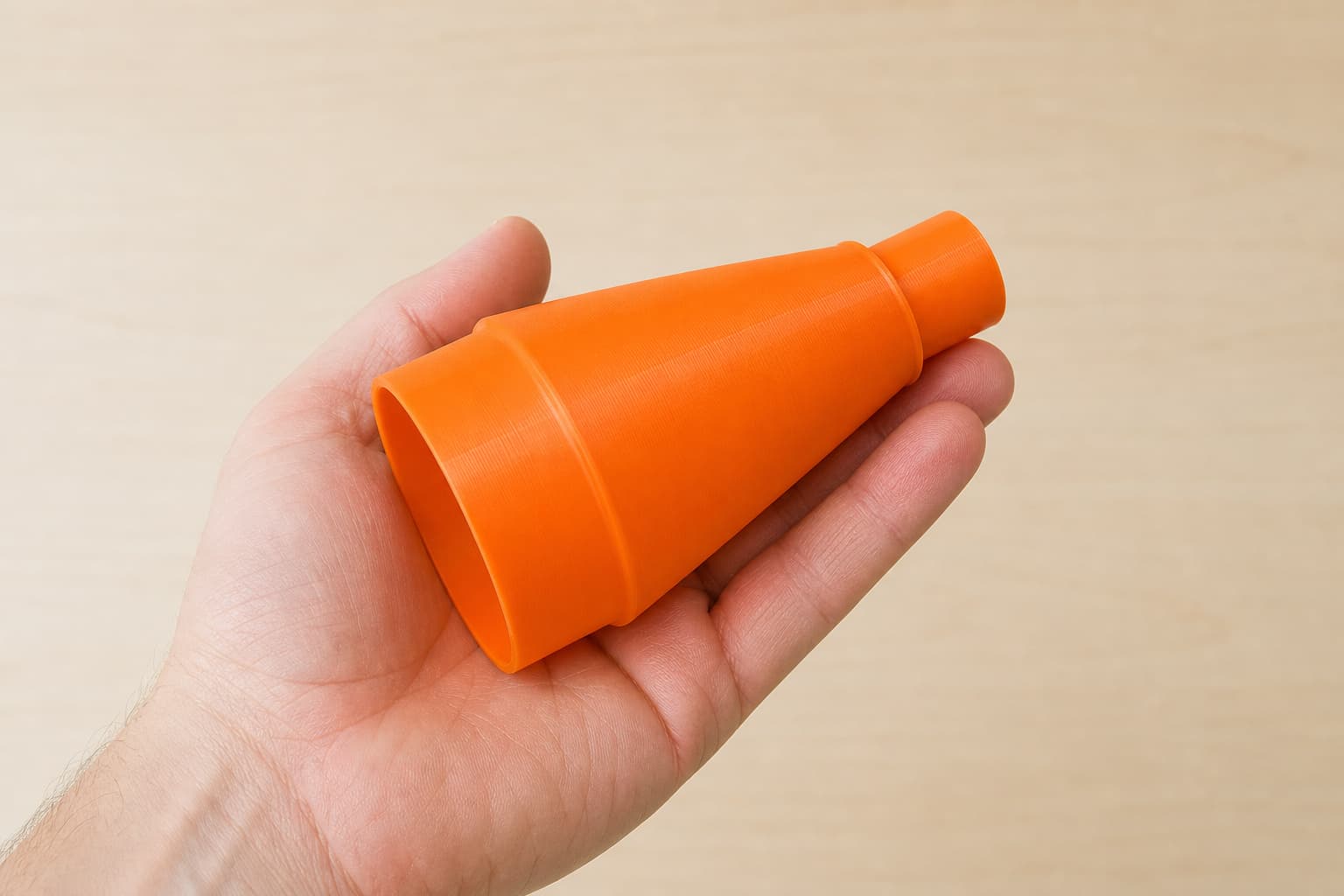 The CMXXSAX69434605 to Festool CT MINI dust adapter held in one hand to show its size