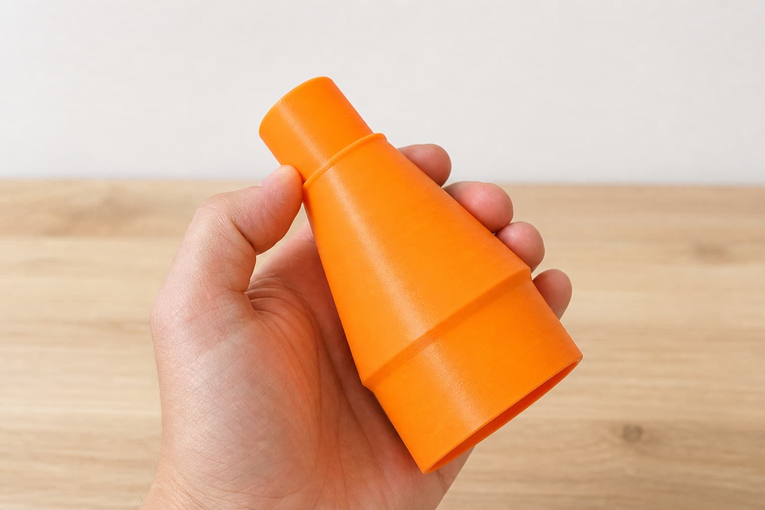 The BW9501-00 to 1.25" Duct dust adapter held in one hand to show its size