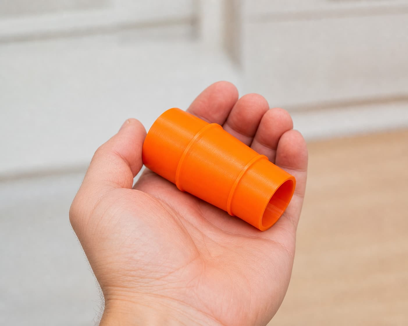 The 59313 to 2.25" Duct dust adapter held in one hand to show its size