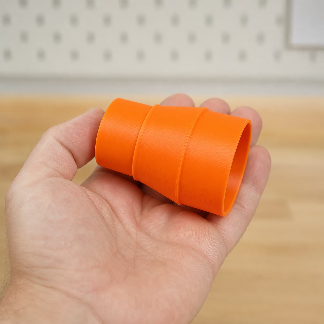 The 2012NB to 2.25" Duct dust adapter held in one hand to show its size