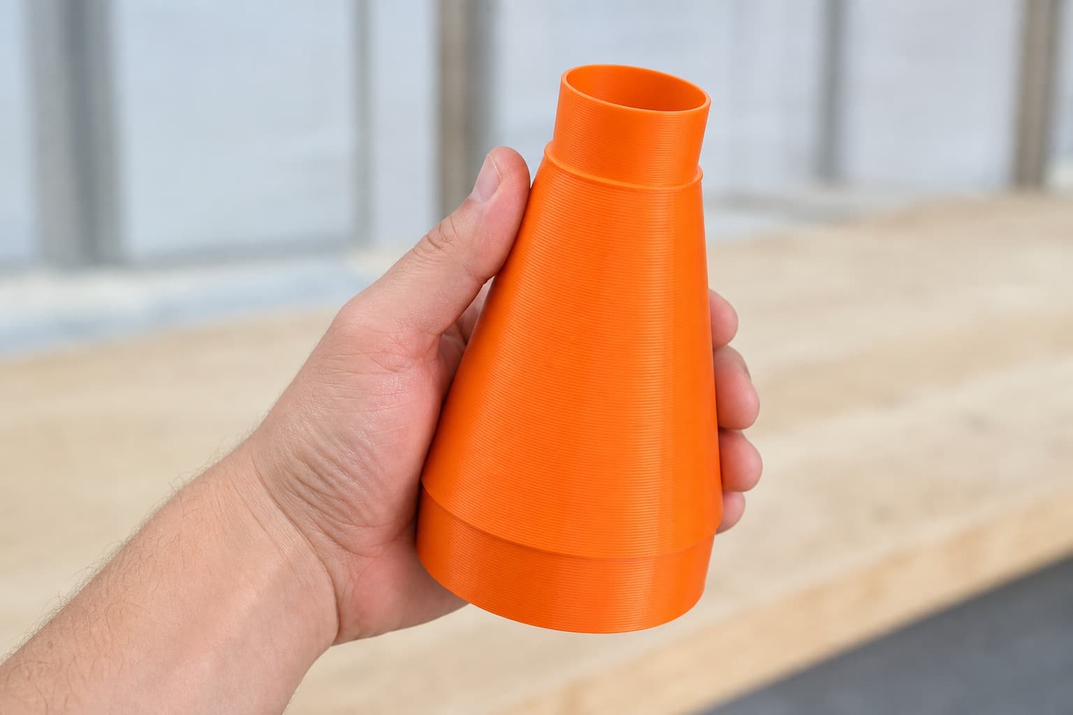The 50110CC-WHD to Craftsman 20G dust adapter held in one hand to show its size